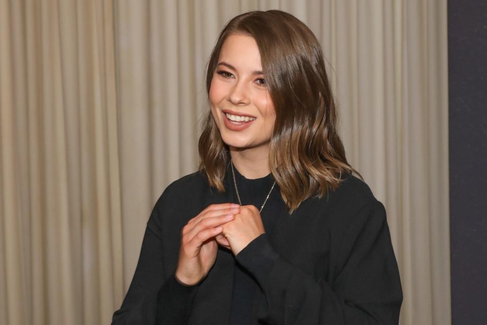 Bindi Irwin holds a necklace featuring a portrait of her father at the 2023 Steve Irwin Gala Dinner.