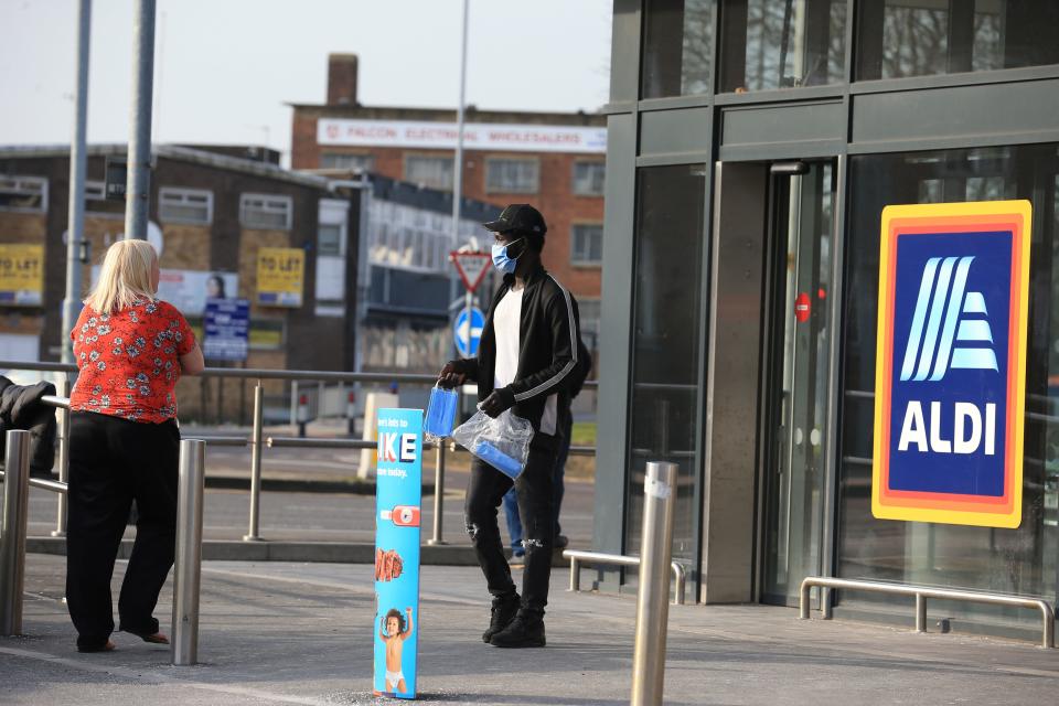 A man sells face masks outside a supermarket the centre of  Leeds, northern England, on March 24, 2020 after Britain ordered a lockdown to slow the spread of the novel coronavirus. - Britain was under lockdown March 24, its population joining around 1.7 billion people around the globe ordered to stay indoors to curb the "accelerating" spread of the coronavirus. (Photo by Lindsey Parnaby / AFP) (Photo by LINDSEY PARNABY/AFP via Getty Images)