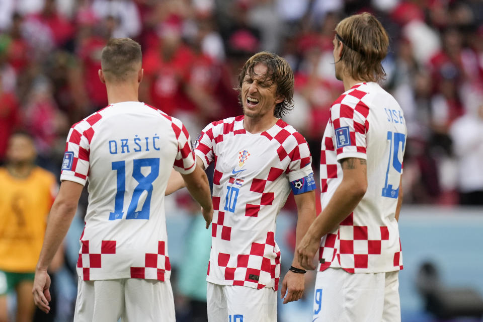 Croatia's Mislav Orsic (18), Luka Modric (10) and Borna Sosa (19) react following the World Cup group F soccer match between Morocco and Croatia, at the Al Bayt Stadium in Al Khor , Qatar, Wednesday, Nov. 23, 2022. (AP Photo/Themba Hadebe)