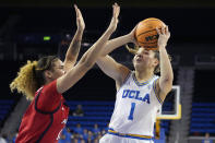 UCLA guard Kiki Rice, right, shoots as Arizona forward Esmery Martinez defends during the second half of an NCAA college basketball game Friday, Feb. 3, 2023, in Los Angeles. (AP Photo/Mark J. Terrill)