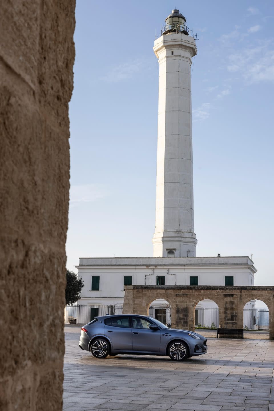 a car parked in front of a tall tower