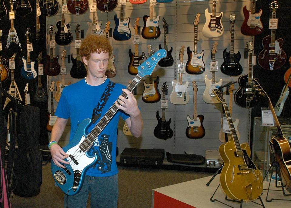Sam Ash stores nationwide have begin going-out-of-business sales. The music store in Charlotte, seen with a young man rocking out in this 2008 file photo, has long been a staple in the city. Observer file photo