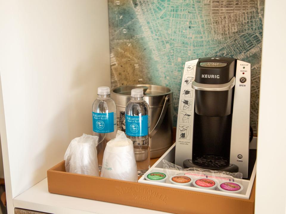 a keurig and water bottles inside the hotel room