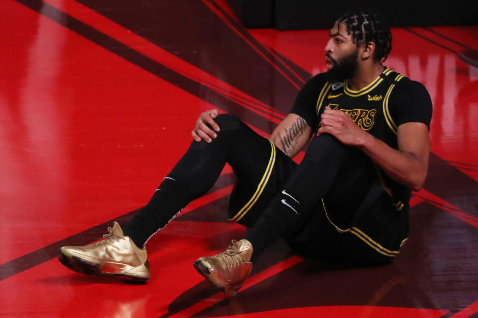 LAKE BUENA VISTA, FLORIDA - OCTOBER 09: Anthony Davis #3 of the Los Angeles Lakers goes down on the court during the fourth quarter against the Miami Heat in Game Five of the 2020 NBA Finals at AdventHealth Arena at the ESPN Wide World Of Sports Complex on October 9, 2020 in Lake Buena Vista, Florida. NOTE TO USER: User expressly acknowledges and agrees that, by downloading and or using this photograph, User is consenting to the terms and conditions of the Getty Images License Agreement. (Photo by Sam Greenwood/Getty Images)