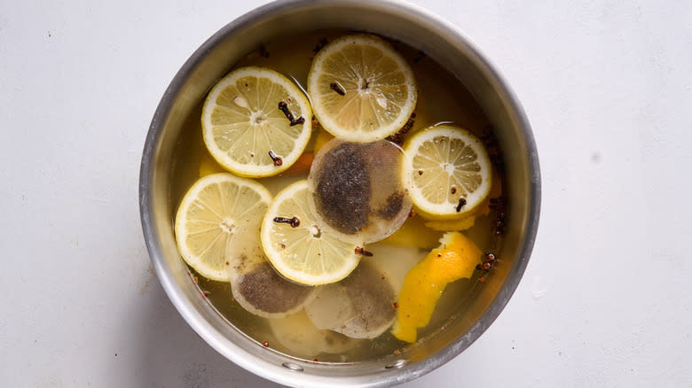 lemon slices and tea bags in pot