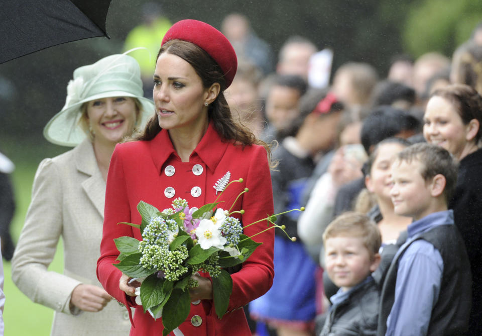 Britain's Kate, the Duchess of Cambridge, attends the official welcome ceremony at Government House, in Wellington, New Zealand, Monday, April 7, 2014. Britain's Prince William and his wife, Kate, arrived in New Zealand's capital to cheers from locals who braved windy, rainy weather to catch a glimpse of the royal couple. (AP Photo/SNPA, Ross Setford) NEW ZEALAND OUT