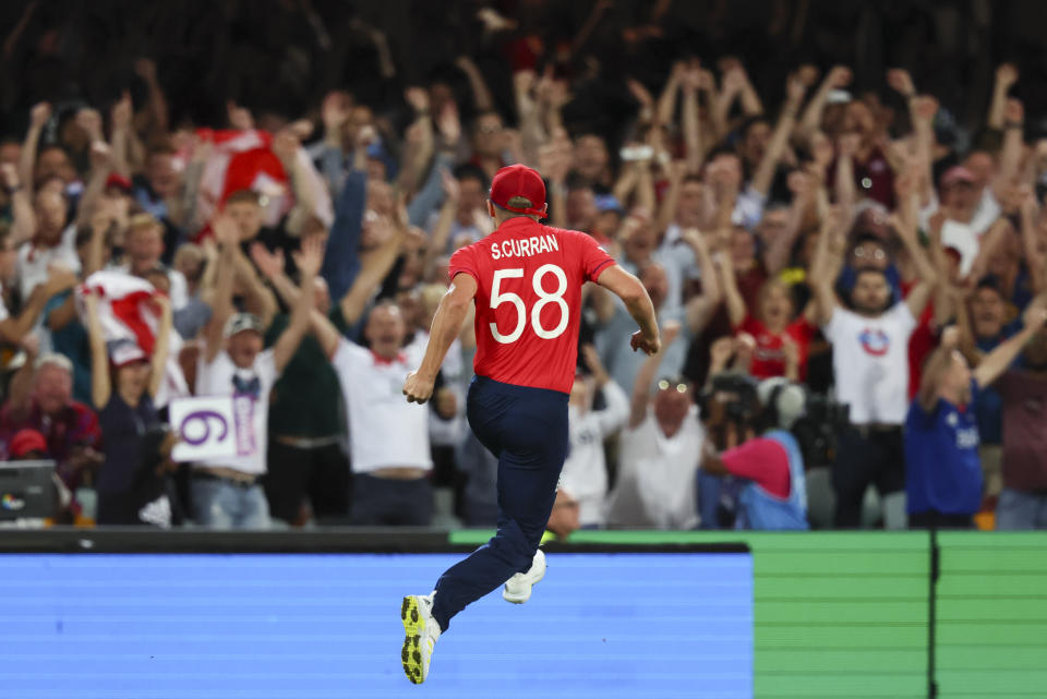 England's Sam Curran celebrates after taking a catch to dismiss New Zealand's James Neesham during the T20 World Cup cricket match between England and New Zealand in Brisbane, Australia, Tuesday, Nov. 1, 2022. (AP Photo/Tertius Pickard)