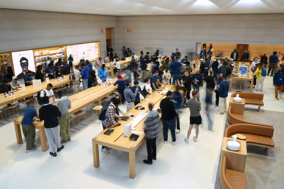 People shop at the Apple Fifth Avenue store for the release of the Apple iPhone 16, Friday, Sept. 20, 2024, in New York. (AP Photo/Pamela Smith)