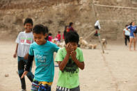 Children play at a makeshift soccer field in Nueva Union shantytown in Villa Maria del Triunfo district of Lima, Peru, May 9, 2018. REUTERS/Mariana Bazo