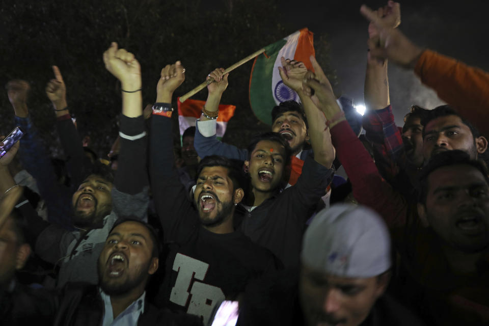 Supporters of India's ruling Bhartiya Janata Party shout slogans as they celebrate reports of Indian aircrafts bombing Pakistan territory, in New Delhi, India, Tuesday, Feb. 26, 2019. A pre-dawn airstrike inside Pakistan that India said targeted a terrorist training camp and killed a "very large number" of militants ratcheted up tensions on Tuesday between the two nuclear-armed rivals at odds over the disputed territory of Kashmir. (AP Photo/Altaf Qadri)