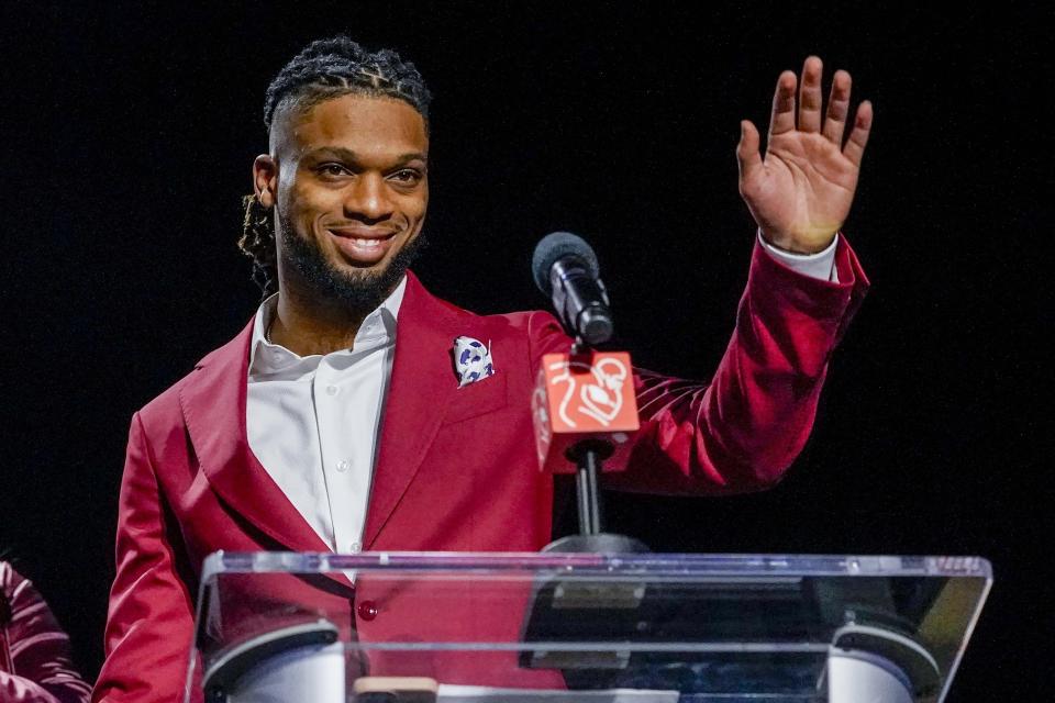 Buffalo Bills' Damar Hamlin waves after being introduced as the winner of the Alan Page Community Award during a news conference on Wednesday, Feb. 8, 2023, in Phoenix. The Kansas City Chiefs will play the Philadelphia Eagles in Super Bowl 57 on Sunday.