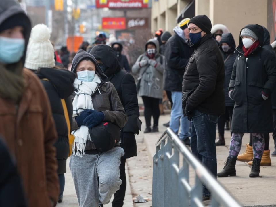 People wait in line at a COVID-19 test site in Toronto on Dec. 22, 2021. (Chris Young/The Canadian Press - image credit)