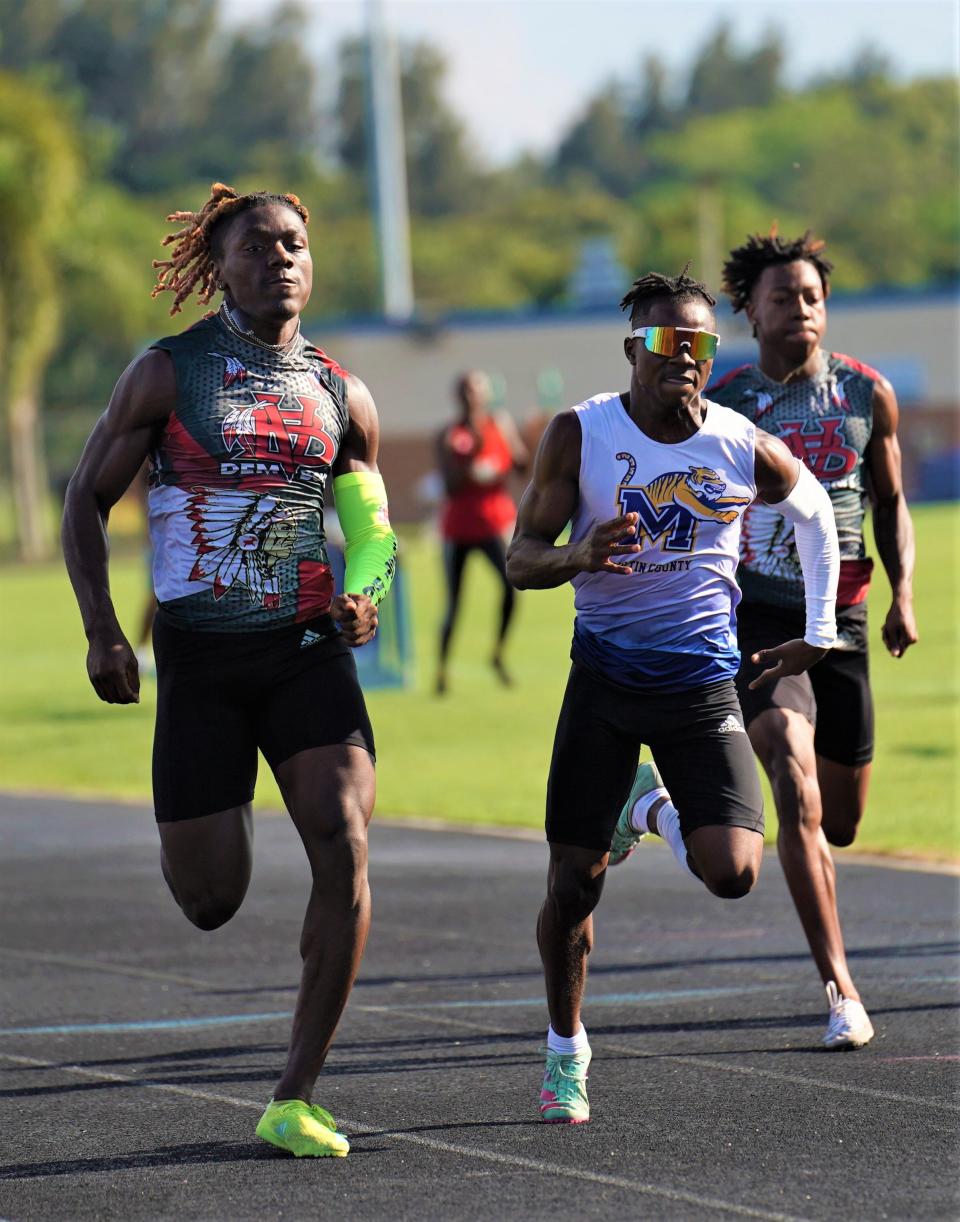 Vero Beach's Derrick Williams and Martin County's Denzel Alexander battle to the finish line in the 100-meter dash at the Treasure Lake Conference track and field championships on Friday, April 14, 2023 in Stuart. Williams clipped Alexander as the two had times of 10.77 and 10.78.