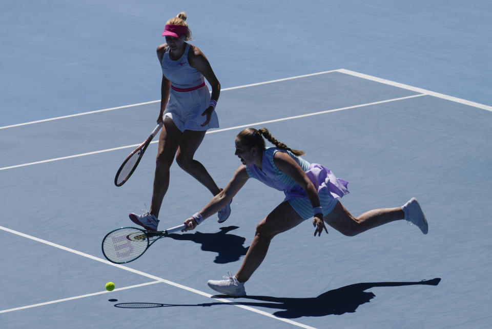 Jelena Ostapenko of Latvia and Lyudmyla Kichenok of Ukraine in action against Hsieh Su-Wei of Taiwan and Elise Mertens of Belgium during the women's doubles final at the Australian Open tennis championships at Melbourne Park, in Melbourne, Australia, Sunday, Jan. 28, 2024. (AP Photo/Alessandra Tarantino)