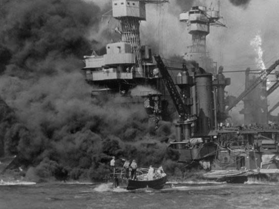 A small boat rescues sailors from the USS 'West Virginia', Doris Miller's ship, after she had suffered a hit (Getty Images)