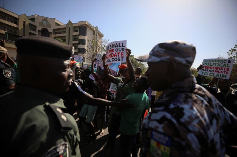 Police officers are seen during the disruption of a freedom rally by opponents of Nigerian activist Omoyele Sowore in Abuja