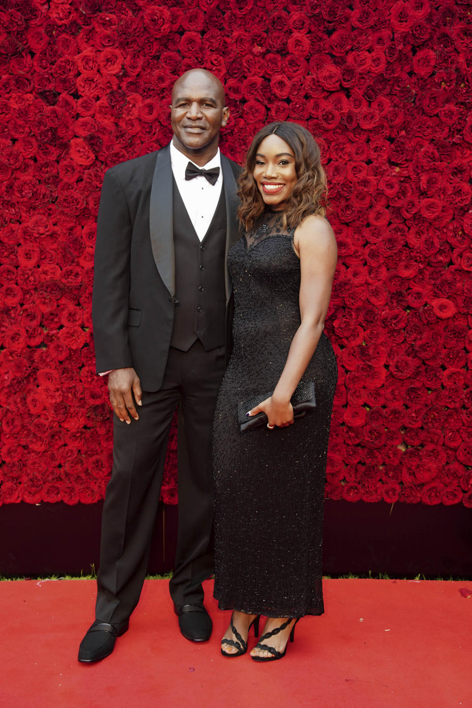 Evander Holyfield and guest pose for a photo on the red carpet at the grand opening of Tyler Perry Studio on Saturday, Oct. 5, 2019, in Atlanta. (Photo by Elijah Nouvelage/Invision/AP)