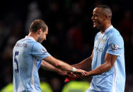 MANCHESTER, ENGLAND - APRIL 30: Vincent Kompany of Manchester City celebrates with team mate Pablo Zabaleta (L) at the end of the Barclays Premier League match between Manchester City and Manchester United at the Etihad Stadium on April 30, 2012 in Manchester, England. (Photo by Alex Livesey/Getty Images)