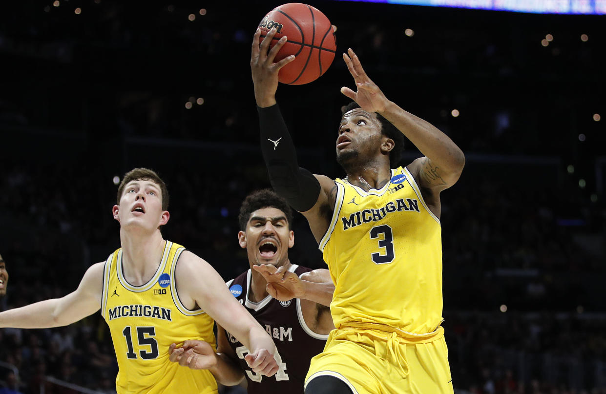 Michigan guard Zavier Simpson (3) shoots against Texas A&M during the first half of an NCAA men’s college basketball tournament regional semifinal Thursday, March 22, 2018, in Los Angeles. (AP Photo/Jae Hong)