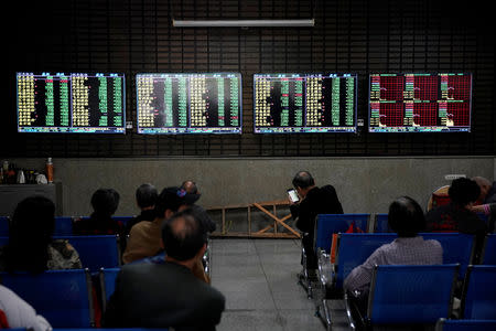 Investors look at screens showing stock information at a brokerage house in Shanghai, China May 6, 2019. REUTERS/Aly Song/Files