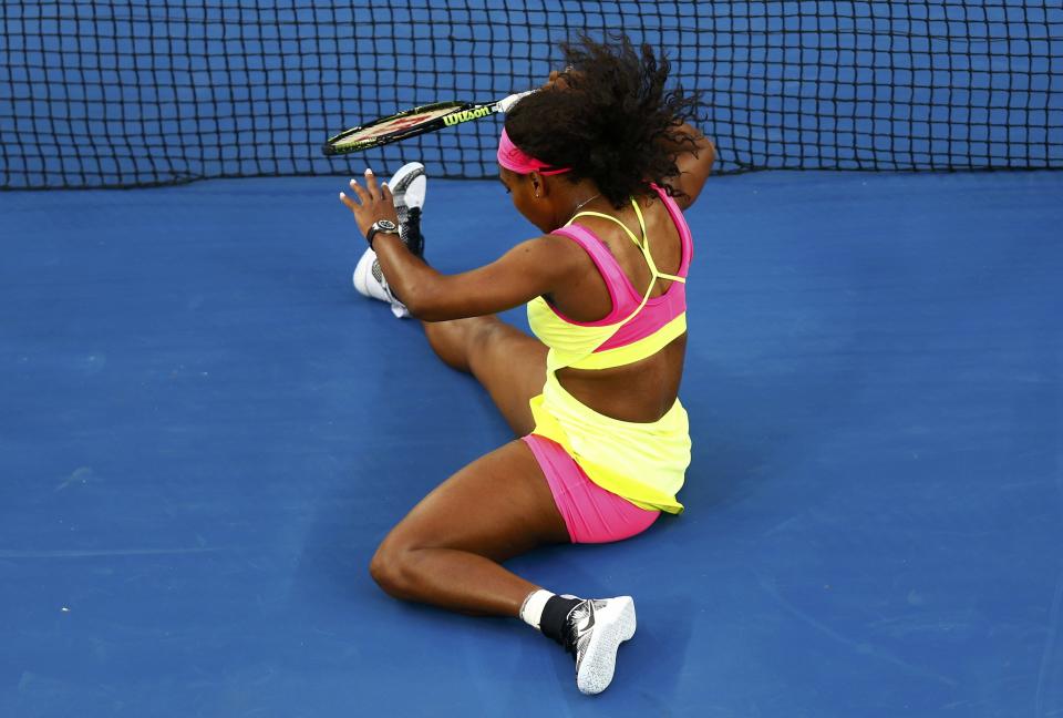 Williams of the U.S. reacts as she slips while chasing after a ball during her women's singles first round match against Van Uytvanck of Belgium at the Australian Open 2015 tennis tournament in Melbourne