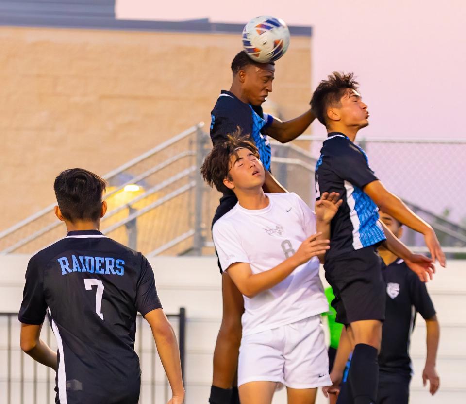Northeast's Beinfait Yonyimiki leaps high for a header during a free kick in Friday night's Class 5A bi-district playoff victory over Hendrickson. The Raiders won 4-2 in a shootout; the match was tied 4-4 after regulation.