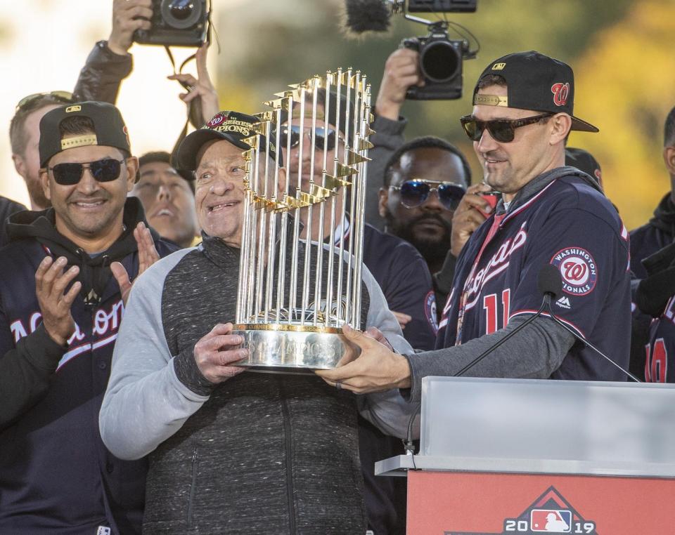 Nationals owner Ted Lerner holds the Commissioner's Trophy after his team defeated the Houston Astros to win the 2019 World Series.