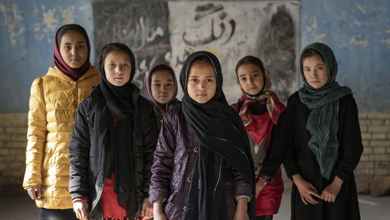 Afghan schoolgirls pose for a photo in a classroom in Kabul, Afghanistan, Thursday, Dec. 22, 2022. The country’s Taliban rulers ordered women nationwide to stop attending private and public universities. They have banned girls from middle school and high school, barred women from most fields of employment and ordered them to wear head-to-toe clothing in public. Women are also banned from parks and gyms. 