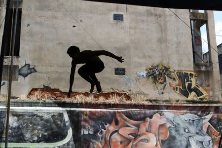 Anderson Rodriguez trains on a slackline at a National Circus of Venezuela venue in Caracas, Venezuela, April 5, 2019. REUTERS/Ivan Alvarado