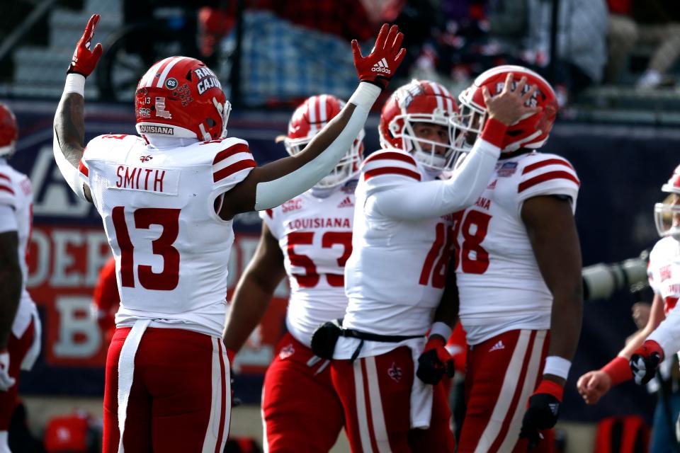 Dec 23, 2022; Shreveport, Louisiana, USA; Louisiana-Lafayette Ragin' Cajuns running back Chris Smith (13) reacts after a touchdown during the first half against the Houston Cougars in the 2022 Independence Bowl at Independence Stadium. Mandatory Credit: Petre Thomas-USA TODAY Sports