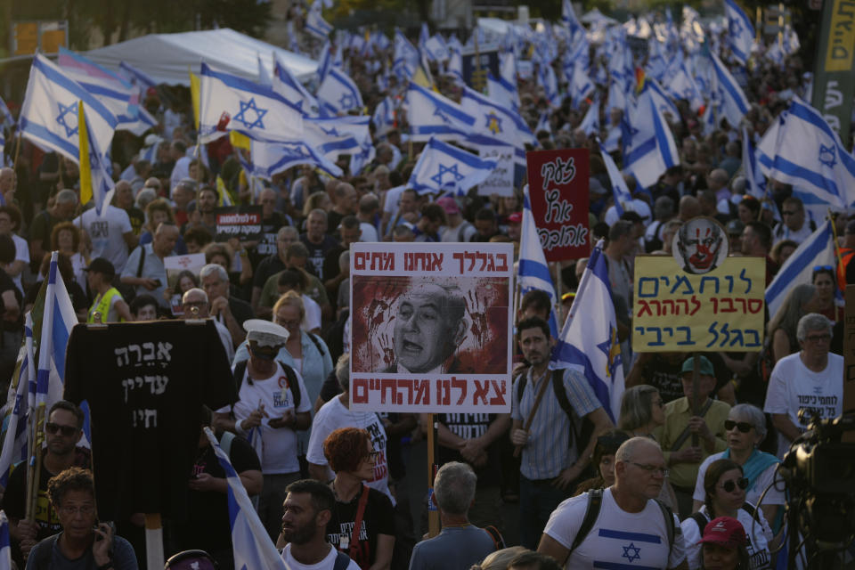 People take part in a protest against Israeli Prime Minister Benjamin Netanyahu's government, demanding new elections and the release of the hostages held in the Gaza Strip, outside of the Knesset, Israel's parliament, in Jerusalem, Monday, June 17, 2024. (AP Photo/Ohad Zwigenberg)