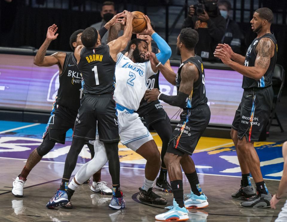 The Lakers' Andre Drummond is defended by several Brooklyn Nets during the first half April 10, 2021.