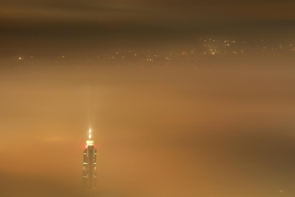 The Avaz Twist Tower building rises above as smog covers Sarajevo, Bosnia, Tuesday, Dec. 19, 2023. According to a Swiss air quality company, Sarajevo is one of the most polluted cities in the world. (AP Photo/Armin Durgut)