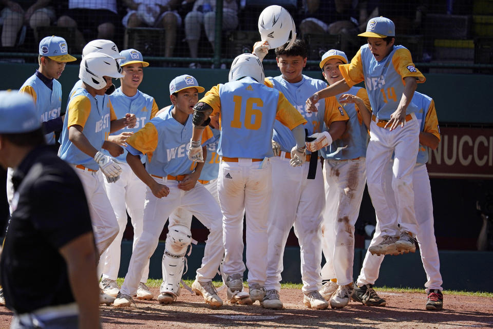 Honolulu's Cohen Sakamoto (16) jumps on home plate after hitting a solo home run during the second inning of a baseball game against Nolensville, Tenn., at the Little League World Series in South Williamsport, Pa., Wednesday, Aug. 24, 2022. It was Sakamoto's second homer of the game, his first being a grand slam in the first inning. Hawaii won 13-0. (AP Photo/Gene J. Puskar)