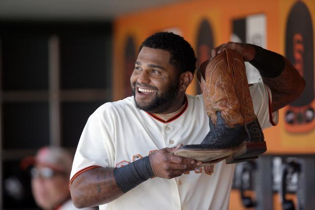 Pablo Sandoval of the San Francisco Giants changes cowboy boots