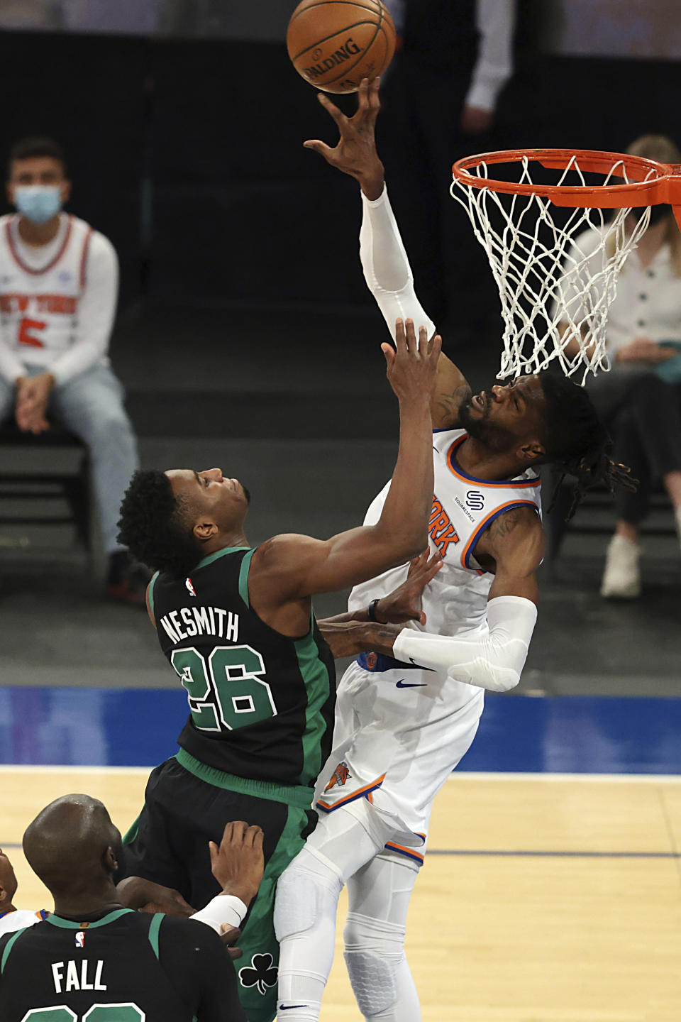 New York Knicks center Nerlens Noel (3) blocks a shot by Boston Celtics forward Aaron Nesmith (26) during the first half of an NBA basketball game in New York, Sunday, May 16, 2021. (Vincent Carchietta/Pool Photo via AP)