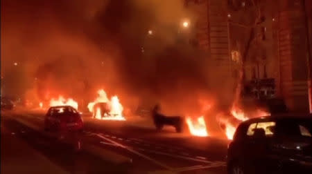 Cars are set on fire during a protest by the "yellow vests" movement in Paris, France, December 29, 2018, in this still image taken from a video obtained from social media. Guilhem Poincignon/via REUTERS