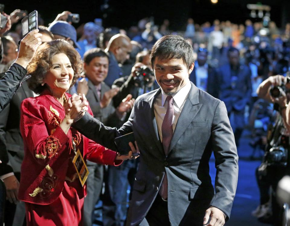 Eight-division world boxing champion Manny "Pac-Man" Pacquiao arrives for a press conference with eleven-time, five-division world champion Floyd "Money" Mayweather  in Los Angeles