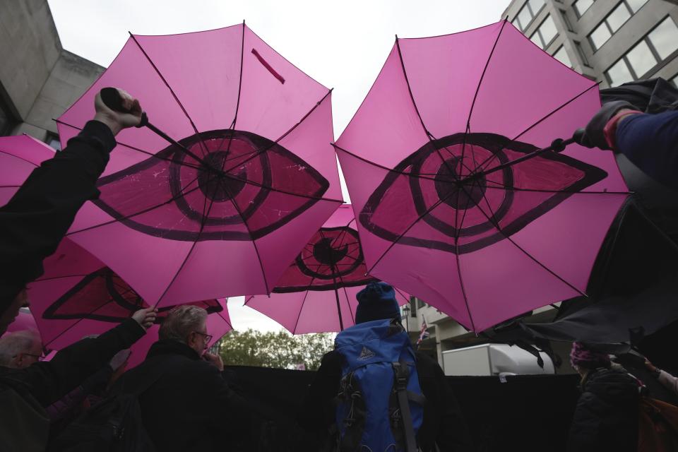 Environmental activists attend the Oily Money Out protest outside the Intercontinental Hotel, in London, Tuesday, Oct. 17, 2023. (AP Photo/Kin Cheung)