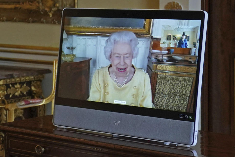 Queen Elizabeth II appears on a screen via videolink from Windsor Castle, where she is in residence, during a virtual audience at Buckingham Palace, London, Tuesday, Oct. 26, 2021. (Victoria Jones/Pool via AP)