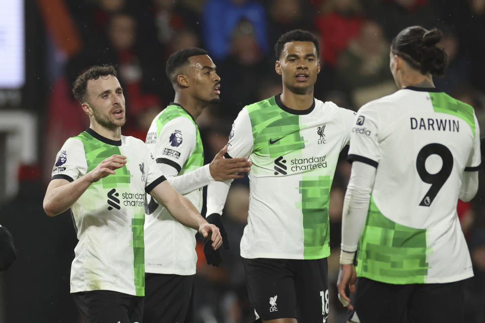 Liverpool's Diogo Jota, left, celebrates with teammates after scoring his side's second goal during the English Premier League soccer match between AFC Bournemouth and Liverpool at the Vitality Stadium, in Bournemouth, England, Sunday, Jan. 21, 2024. (AP Photo/Ian Walton)