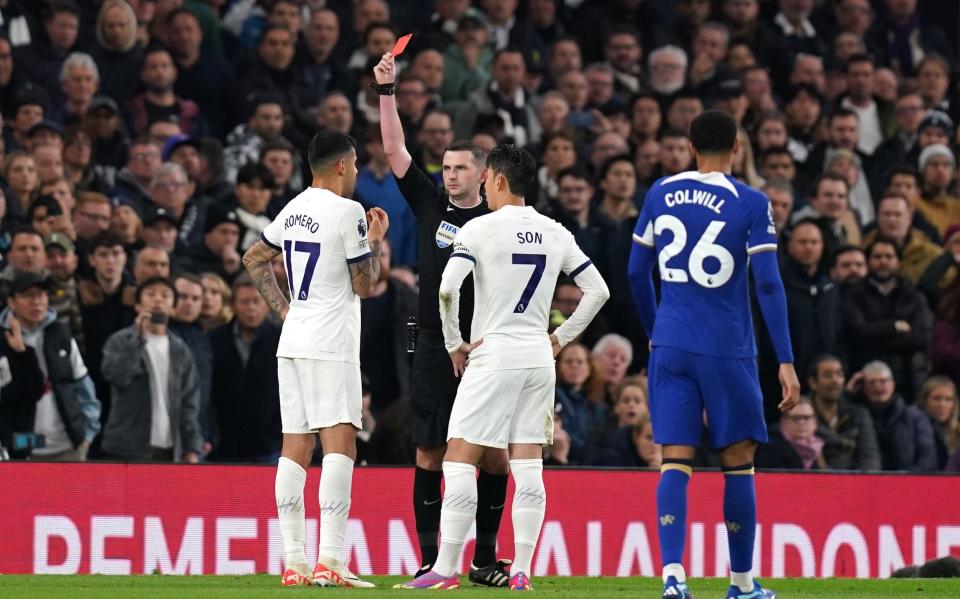 Referee Michael Oliver shows Tottenham Hotspur's Cristian Romero a red card against Chelsea