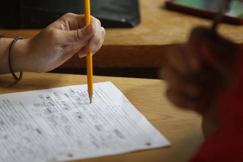 Marisa Varalli (hand at left), Balboa High School World Languages teacher, works with a student on a make up test on Friday, April 8, 2016 in San Francisco, California. (Photo By Lea Suzuki/The San Francisco Chronicle via Getty Images)