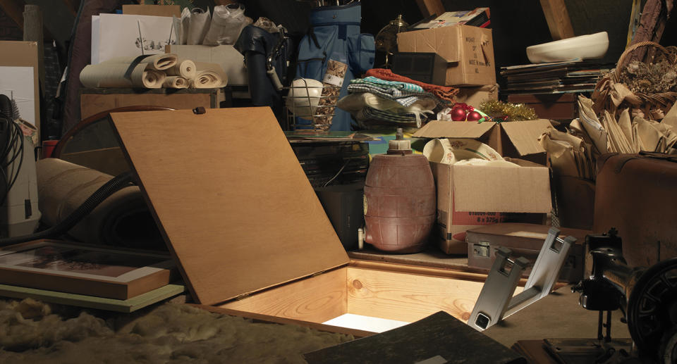 An image of at attic open with various items and furniture around it.