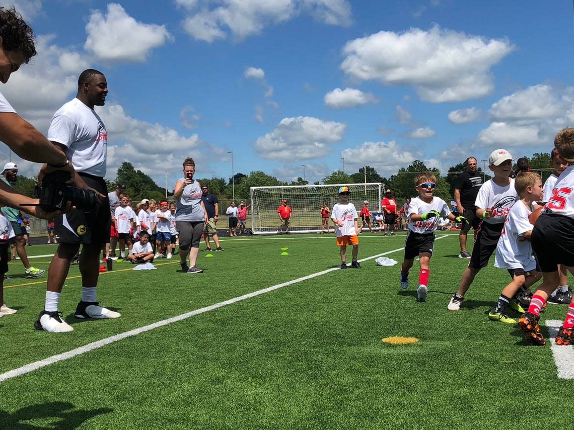 Kansas City Chiefs defensive lineman Chris Jones, left, watches an offensive play during his youth football camp on Wednesday, June 26, 2024 at Blue Valley Southwest High School in Overland Park, Kansas.