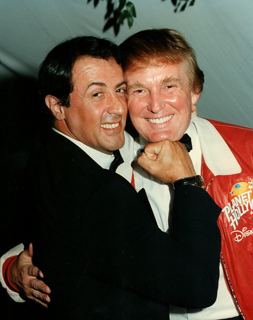 Actor Sylvester Stallone mimes punching Donald Trump at a charity event at a home in Palm Beach, Florida, on Feb. 24, 1997.