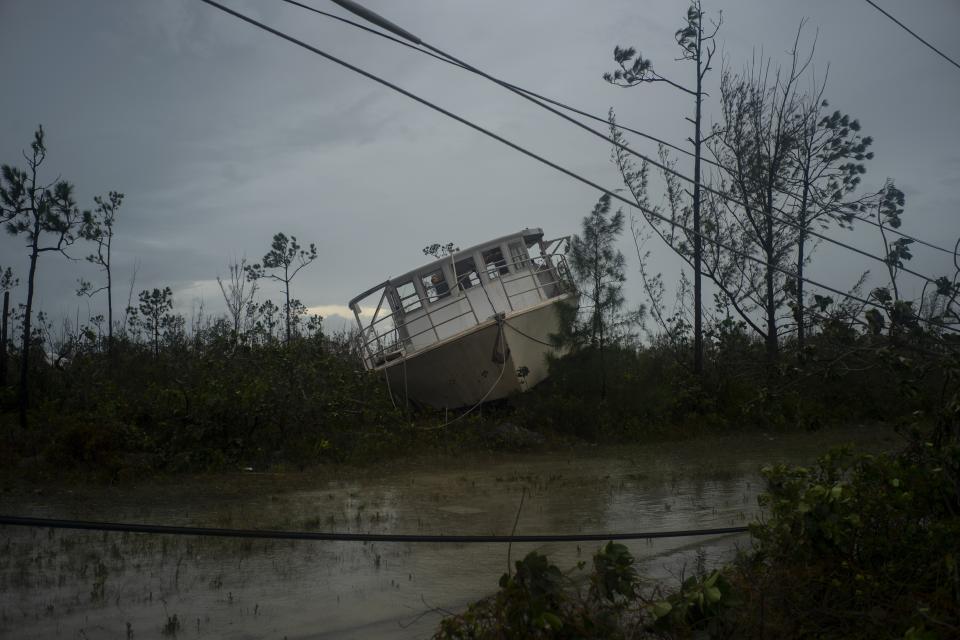 A boat thrown onshore by the Hurricane Dorian lays stranded next to a highway near Freeport, Grand Bahama, Bahamas.