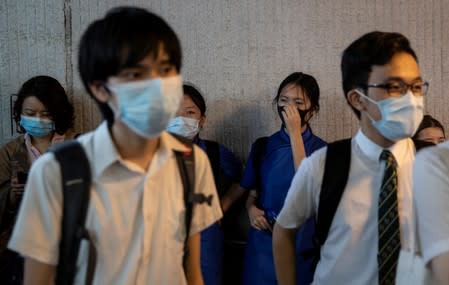 School students shout slogans as they boycott their classes to take part in a protest in Hong Kong