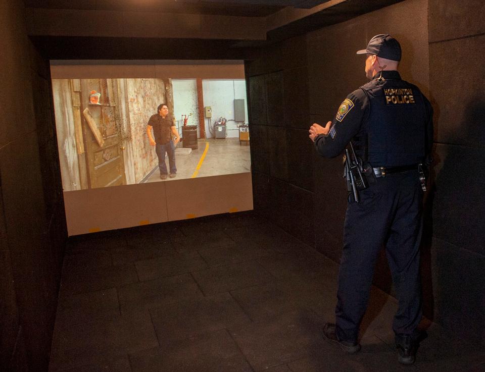 Hopkinton police Sgt. Matthew McNeil participates in an interactive scenario inside the Middlesex Sheriff Mobile Training Center, March 14, 2023.