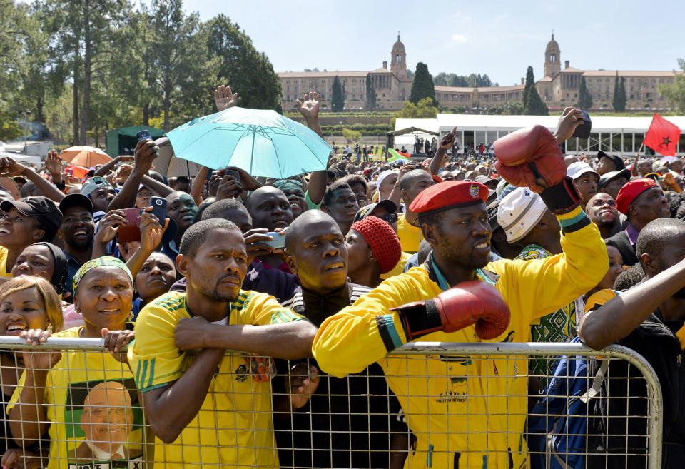 People attend 20-year Democracy Anniversary celebrations near to the government's Union Building, background, in Pretoria, South Africa, Sunday, April 27, 2014. The day marks the end of the apartheid era when all races went to the polls to cast their votes in historic 1994 elections. (AP Photo)